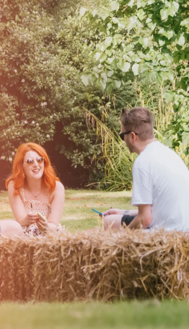 People sitting under a tree on a sunny day,